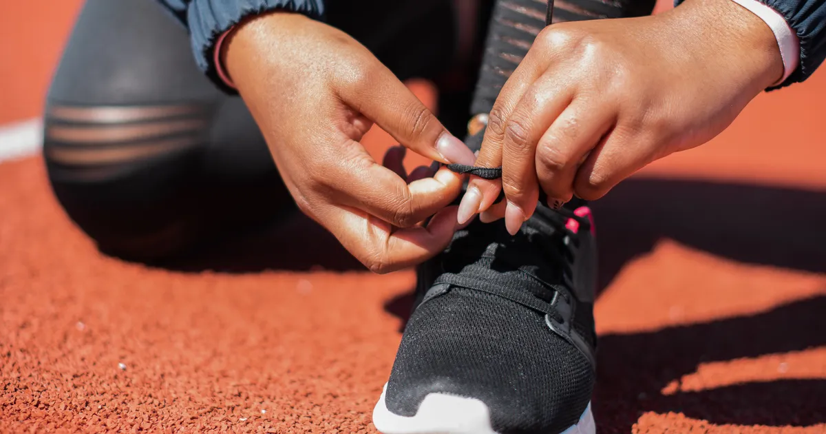 Cushioned running shoe being laced - best shoes for metatarsalgia, Balance Foot & Ankle, Howell MI