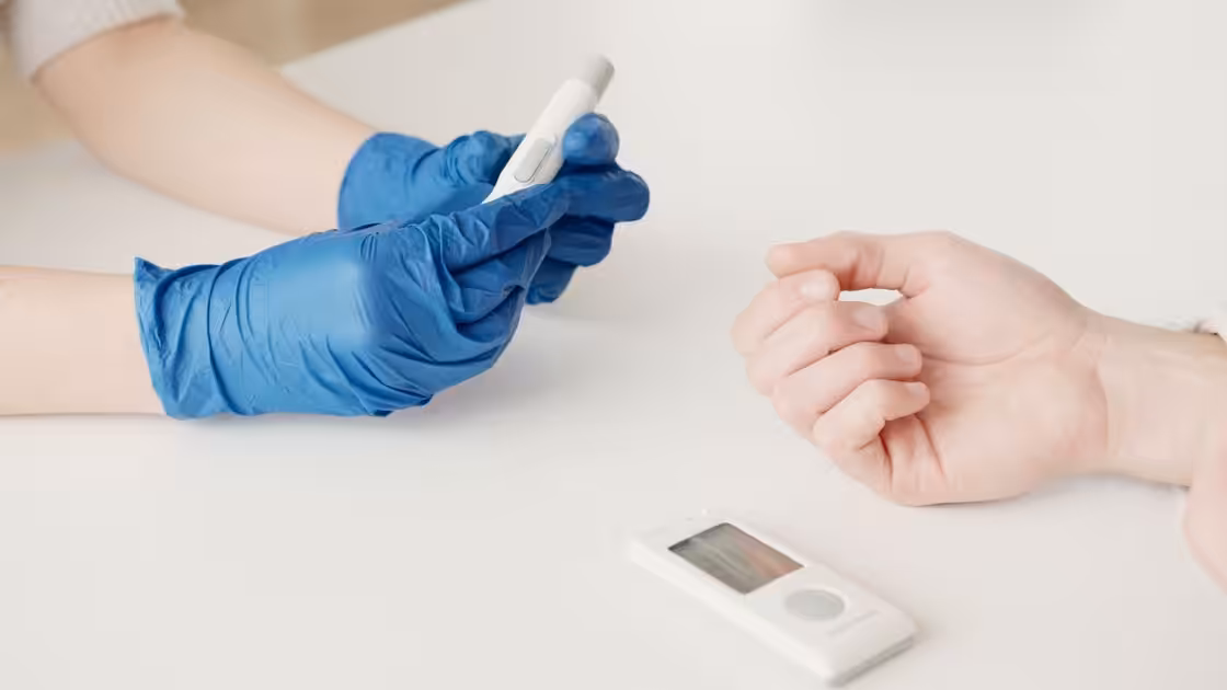 Healthcare worker checking blood glucose — diabetic peripheral neuropathy, Balance Foot & Ankle, Howell MI