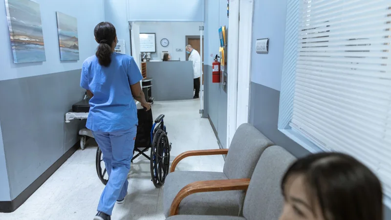 Nurse on her feet during a long hospital shift, showing why supportive shoes matter for standing all day - Howell Michigan podiatrist