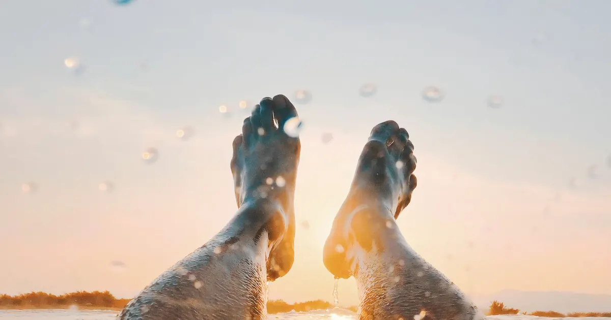Bare feet at the edge of water — foot soak for nail and skin care, Balance Foot & Ankle, Howell MI