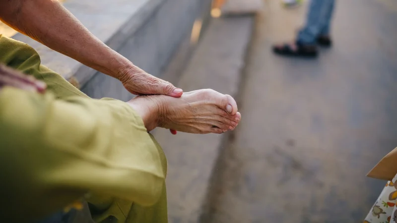 Person massaging the inner arch and ankle where tarsal tunnel nerve pain occurs - Balance Foot & Ankle, Howell MI